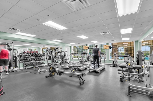 exercise room featuring a paneled ceiling and visible vents