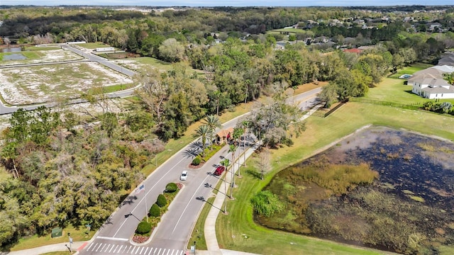 drone / aerial view featuring a wooded view