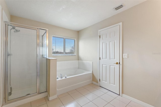 bathroom featuring a stall shower, baseboards, visible vents, tile patterned floors, and a bath