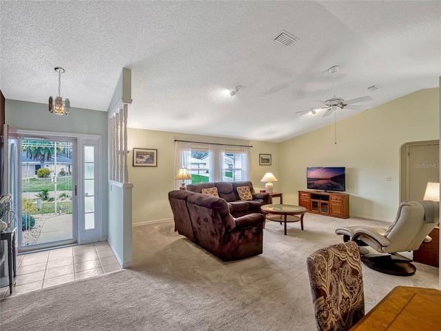 living room with light carpet, visible vents, vaulted ceiling, and arched walkways