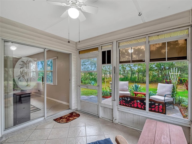 sunroom featuring ceiling fan