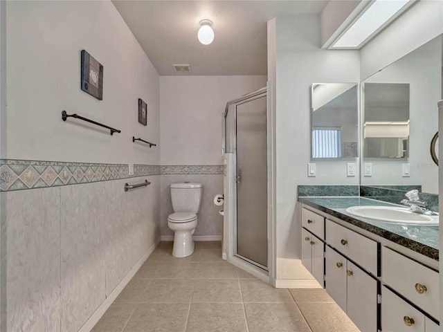 full bathroom with toilet, visible vents, vanity, a shower stall, and tile patterned floors