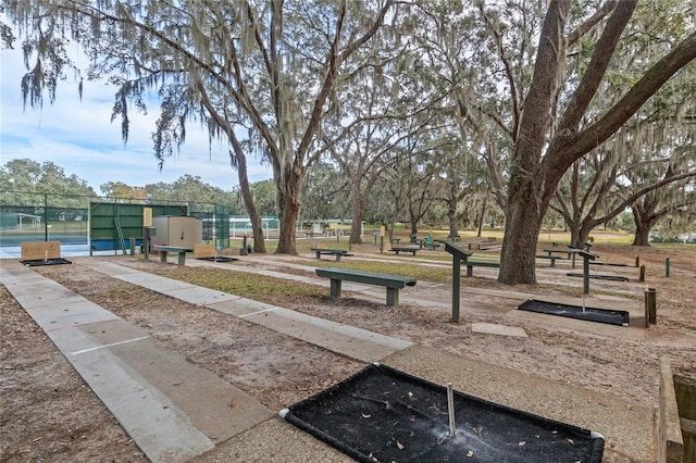 view of home's community featuring fence