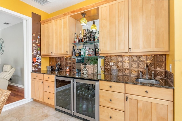 bar featuring wine cooler, indoor wet bar, a sink, and visible vents