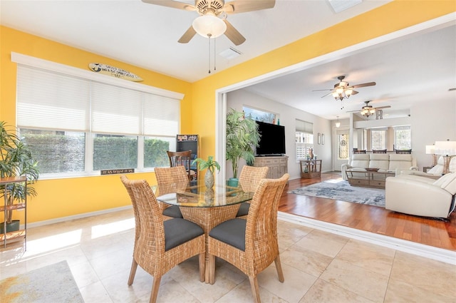 dining area featuring light tile patterned floors, visible vents, and baseboards