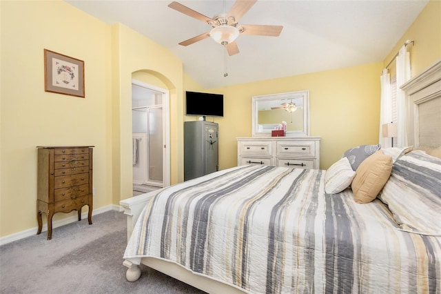 bedroom featuring arched walkways, light colored carpet, a ceiling fan, baseboards, and vaulted ceiling