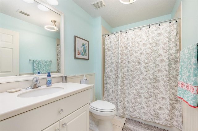 bathroom with tile patterned flooring, visible vents, vanity, and toilet