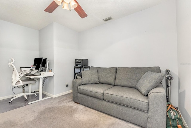 carpeted office featuring a ceiling fan, visible vents, and baseboards