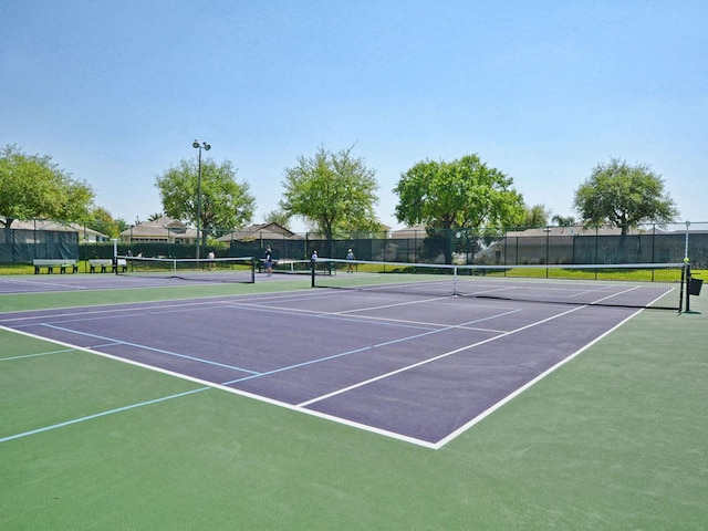 view of sport court with fence