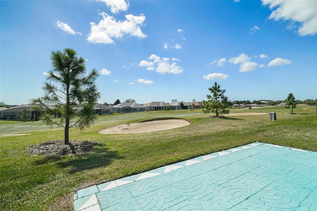 view of property's community featuring a residential view and a yard