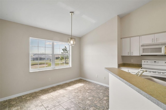 kitchen featuring white appliances, baseboards, vaulted ceiling, white cabinetry, and pendant lighting