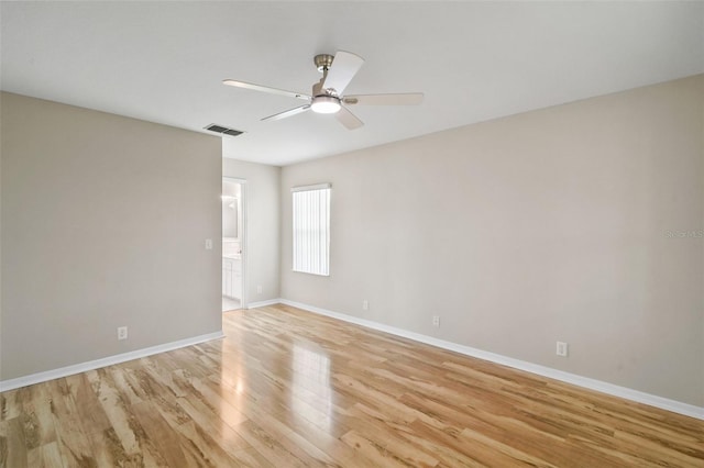 unfurnished room featuring light wood-type flooring, baseboards, visible vents, and a ceiling fan