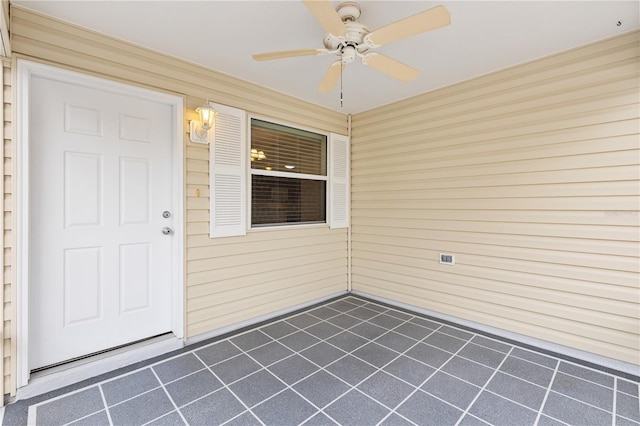 entrance to property featuring ceiling fan