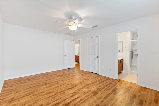 unfurnished bedroom with ensuite bathroom, ceiling fan, light wood-style flooring, visible vents, and baseboards