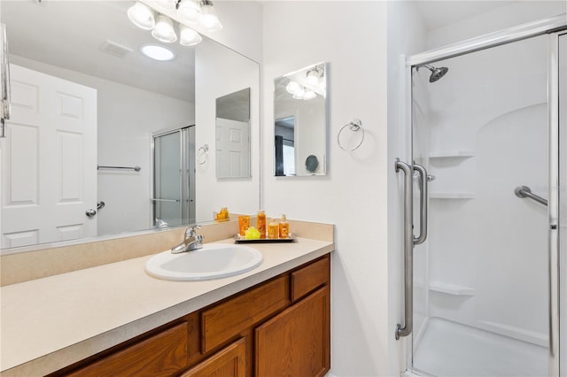 bathroom featuring a stall shower and vanity