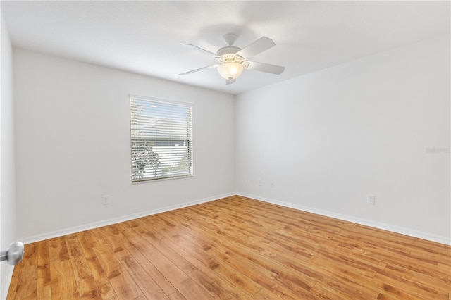 empty room with light wood-style floors, baseboards, and a ceiling fan