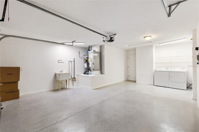 garage featuring heating unit, washing machine and dryer, electric water heater, and a garage door opener