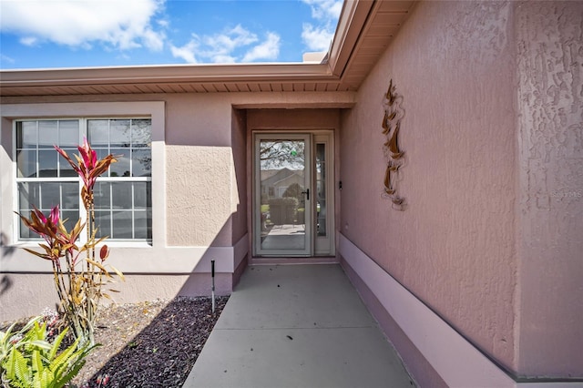 property entrance with stucco siding