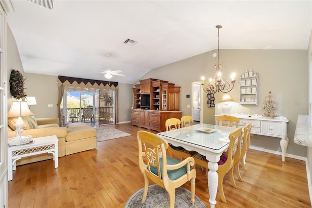 dining area with lofted ceiling, visible vents, light wood finished floors, and ceiling fan with notable chandelier