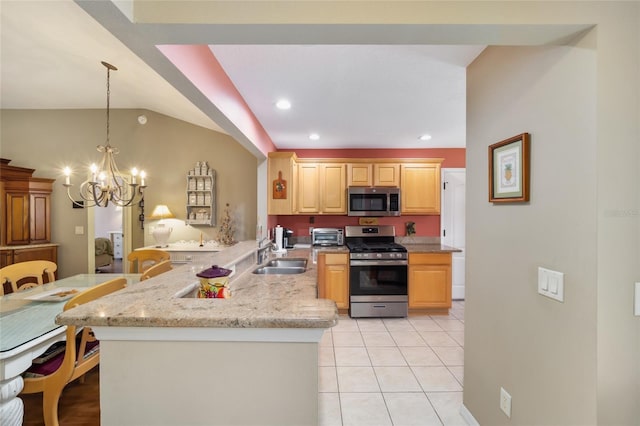 kitchen with stainless steel appliances, a peninsula, a sink, light brown cabinetry, and pendant lighting