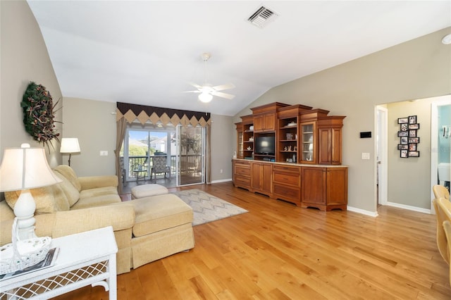 living room with lofted ceiling, light wood-style flooring, visible vents, and ceiling fan