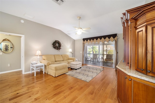 living area with visible vents, light wood-style flooring, vaulted ceiling, ceiling fan, and baseboards