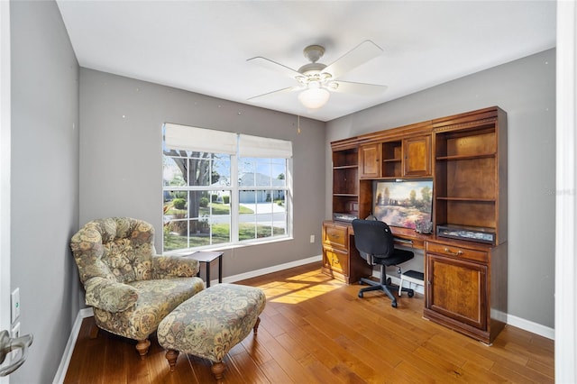 office with a ceiling fan, baseboards, and wood finished floors