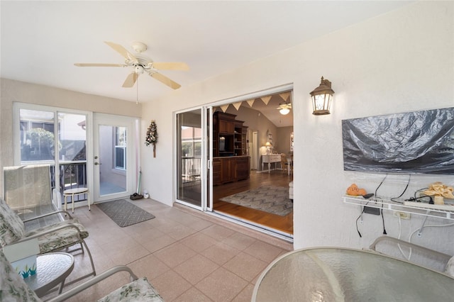 sunroom featuring ceiling fan