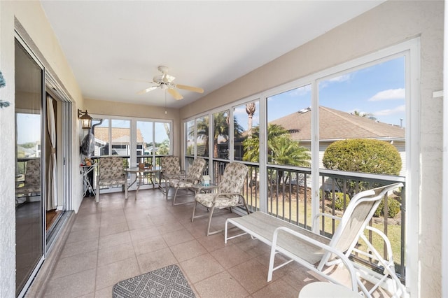 sunroom / solarium with a ceiling fan