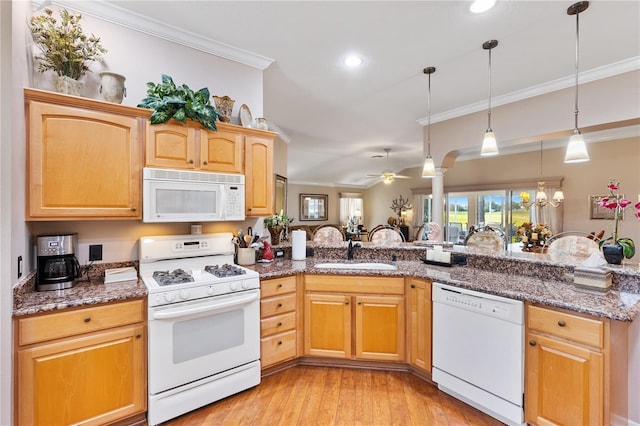 kitchen with crown molding, light wood-style flooring, a sink, dark stone countertops, and white appliances