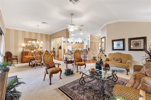 living area with lofted ceiling, ornamental molding, and visible vents