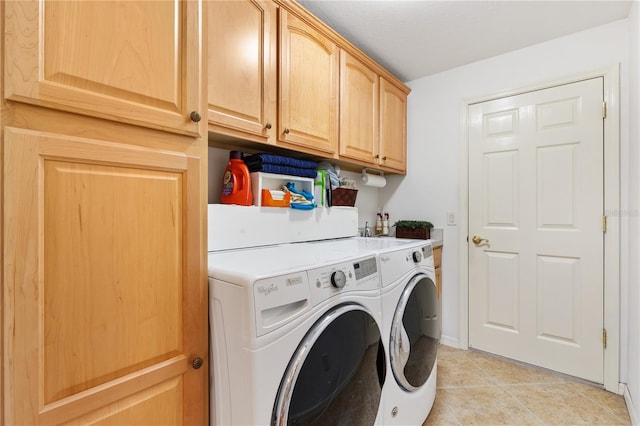 laundry area featuring cabinet space, washer and clothes dryer, and light tile patterned flooring