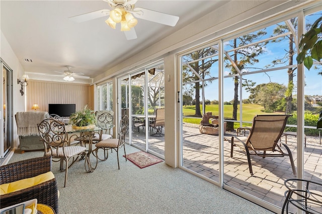 sunroom / solarium with ceiling fan and visible vents