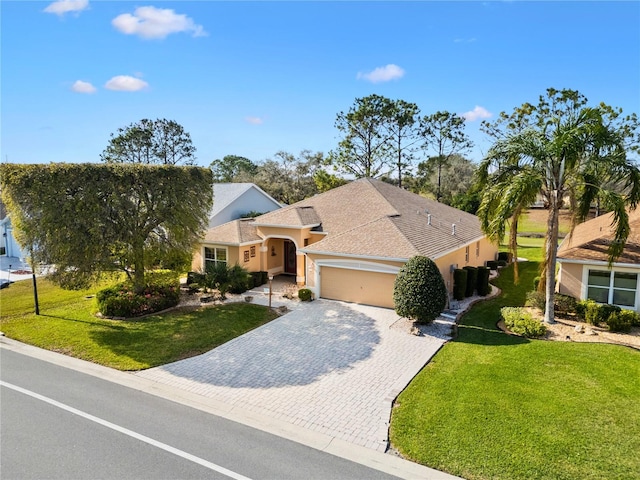 view of front of property with a garage, roof with shingles, decorative driveway, a front lawn, and stucco siding