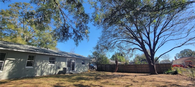 view of yard featuring cooling unit and fence