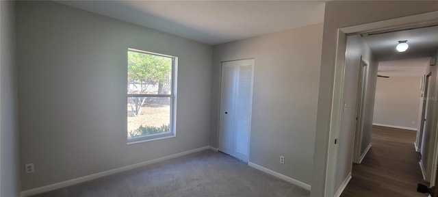 unfurnished bedroom featuring multiple windows, baseboards, and a closet