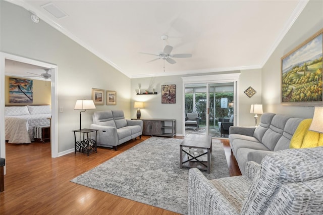 living room with lofted ceiling, ceiling fan, ornamental molding, and wood finished floors