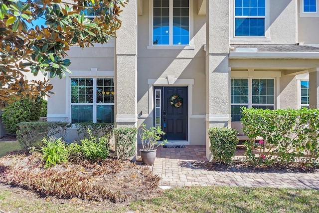 view of exterior entry featuring stucco siding