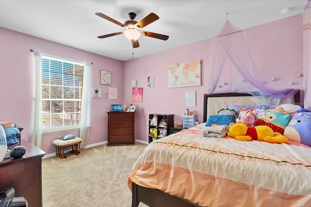 bedroom featuring light carpet, ceiling fan, and baseboards