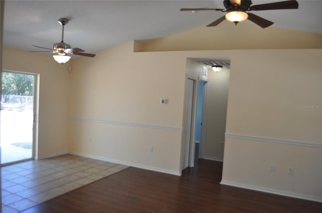 unfurnished room with lofted ceiling, dark wood-type flooring, a ceiling fan, visible vents, and baseboards