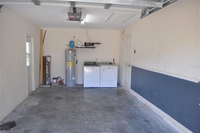 garage with a garage door opener, electric water heater, and independent washer and dryer