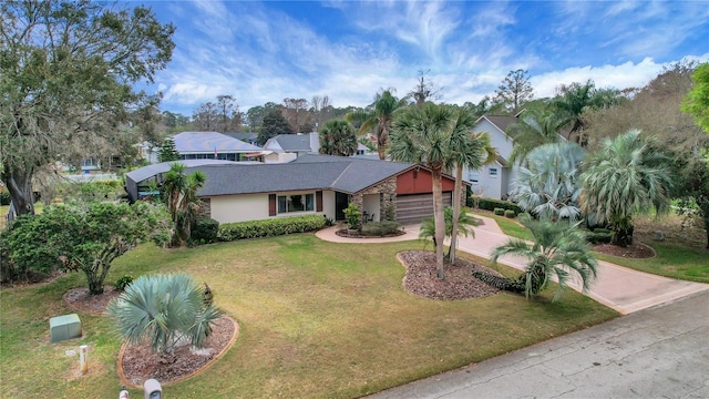 12338 S Putney Ct, Leesburg, FL 34788 - view of front of home with concrete driveway, a front lawn, an attached garage, and stucco siding