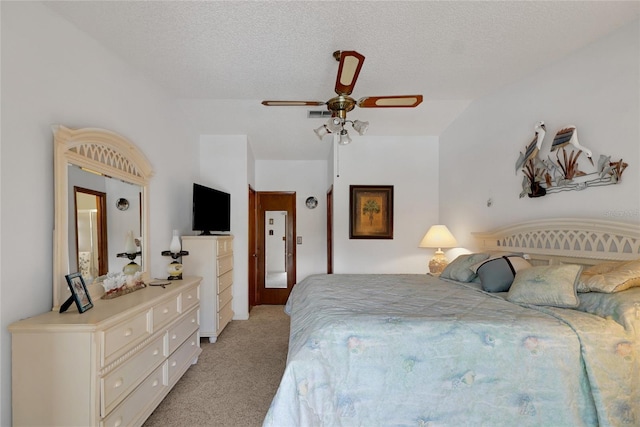 12338 S Putney Ct, Leesburg, FL 34788 - bedroom featuring light carpet, ceiling fan, and a textured ceiling