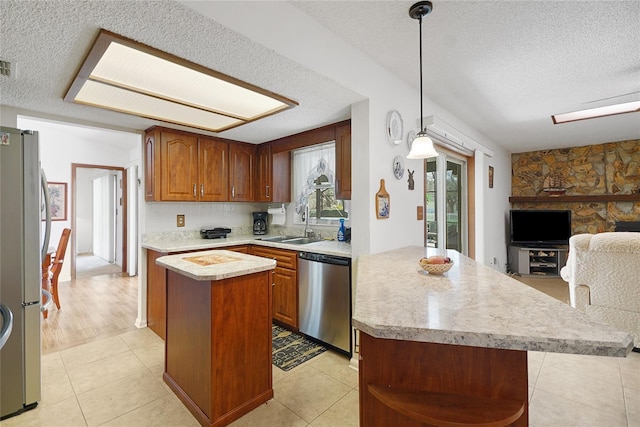 12338 S Putney Ct, Leesburg, FL 34788 - kitchen featuring a sink, a kitchen island, light countertops, appliances with stainless steel finishes, and open shelves