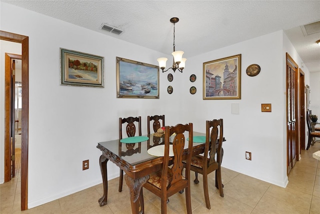 12338 S Putney Ct, Leesburg, FL 34788 - dining area with light tile patterned floors, visible vents, a textured ceiling, and an inviting chandelier