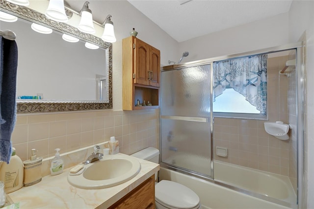 12338 S Putney Ct, Leesburg, FL 34788 - full bathroom featuring tile walls, toilet, enclosed tub / shower combo, vanity, and a textured ceiling