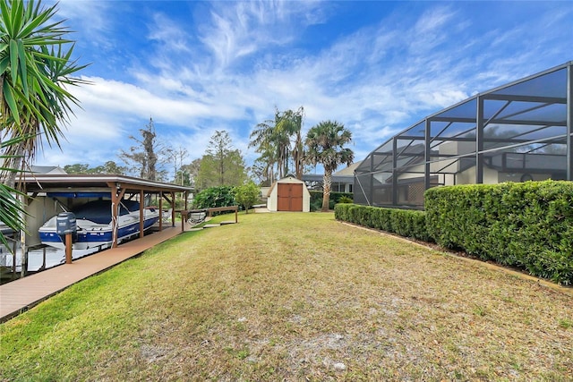 12338 S Putney Ct, Leesburg, FL 34788 - view of yard with boat lift, a shed, a boat dock, and an outdoor structure