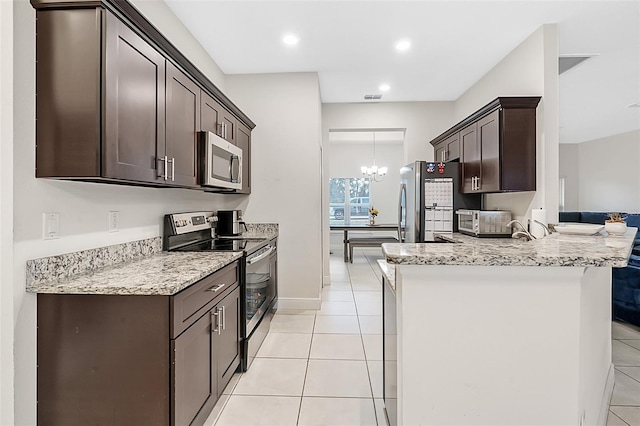 kitchen with light tile patterned floors, a notable chandelier, a peninsula, visible vents, and appliances with stainless steel finishes