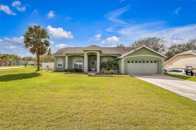 view of front of home featuring an attached garage, driveway, a front yard, and stucco siding