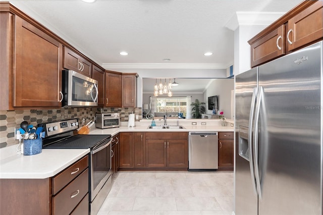 kitchen featuring stainless steel appliances, a sink, and light countertops